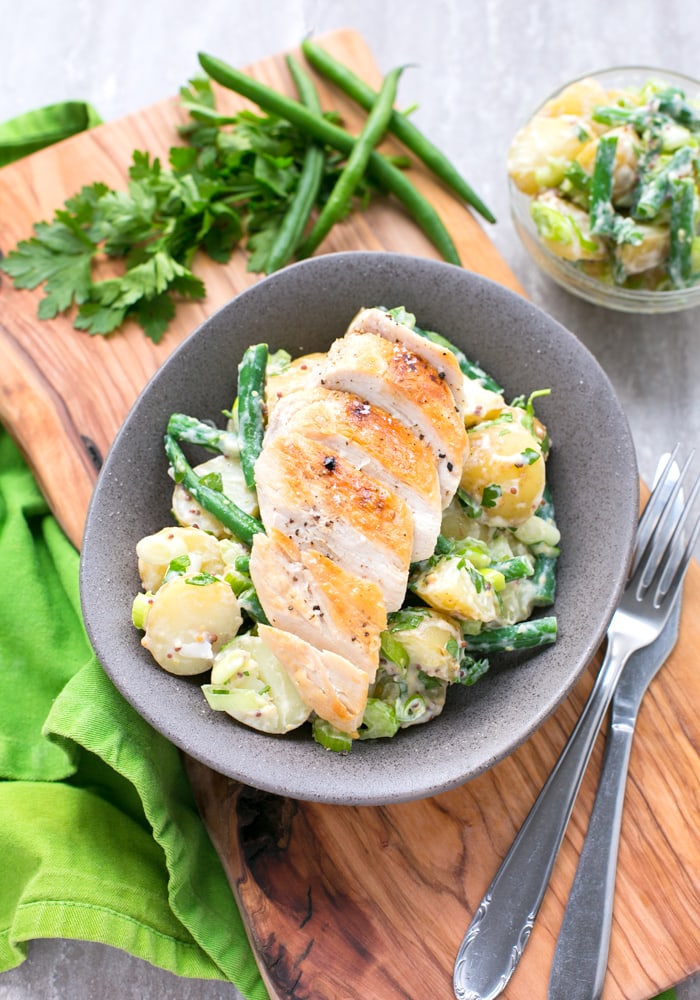 Grilled chicken with potato salad and green beans.