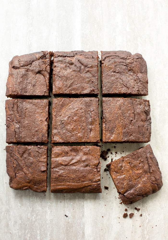 espresso brownies cut into squares, arranged in a grid style, with the brownie in the left down corner slightly in an oblique position.