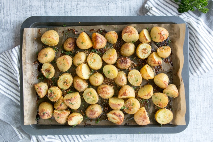 recipe step 2: truffle pesto roasted potatoes on a baking sheet