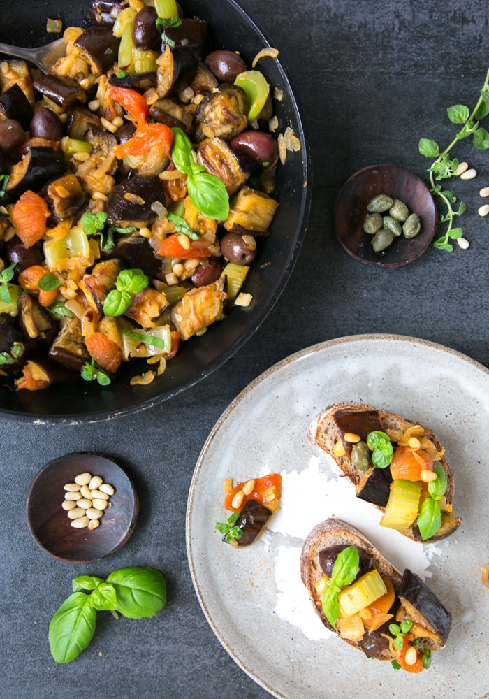 Eggplant caponata served as bruschetta and in a pan.