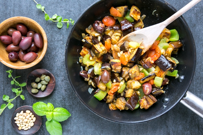 Caponata aubergine stew topped with olives, capers and pinenuts.