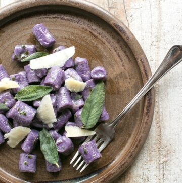 These Purple Potato Gnocchi with Sage and Butter are loaded with flavour - Soft pillowy purple potato gnocchi meet a velvety butter sauce and crunchy fragrant sage leaves to make a beautifully simple meal the whole family will be excited to dig in! Recipe by The Petite Cook