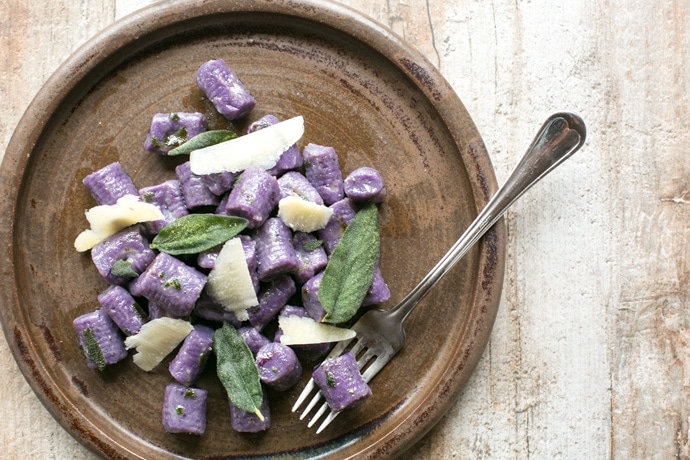 These Purple Potato Gnocchi with Sage and Butter are loaded with flavour - Soft pillowy purple potato gnocchi meet a velvety butter sauce and crunchy fragrant sage leaves to make a beautifully simple meal the whole family will be excited to dig in! Recipe by The Petite Cook