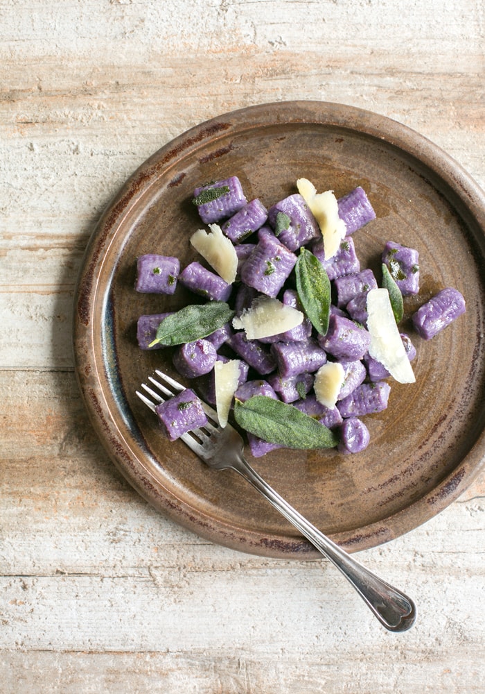 These Purple Potato Gnocchi with Sage and Butter are loaded with flavour - Soft pillowy purple potato gnocchi meet a velvety butter sauce and crunchy fragrant sage leaves to make a beautifully simple meal the whole family will be excited to dig in! Recipe by The Petite Cook