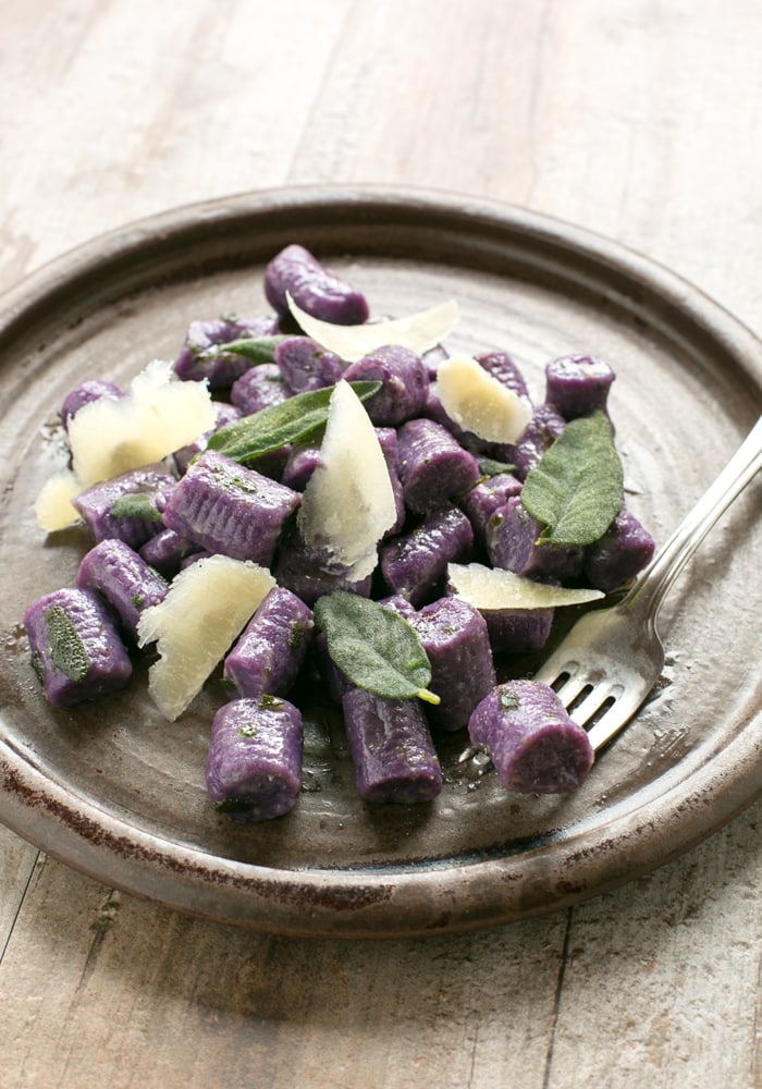 These Purple Potato Gnocchi with Sage and Butter are loaded with flavour - Soft pillowy purple potato gnocchi meet a velvety butter sauce and crunchy fragrant sage leaves to make a beautifully simple meal the whole family will be excited to dig in! Recipe by The Petite Cook