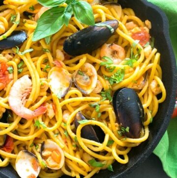 The easiest Seafood Fresh Pasta recipe, made with clams, mussels, squid and shrimp in a creamy and rich tomato sauce. A quick and delicious dinner that you can whip up in less than 20 mins! Recipe by The Petite Cook