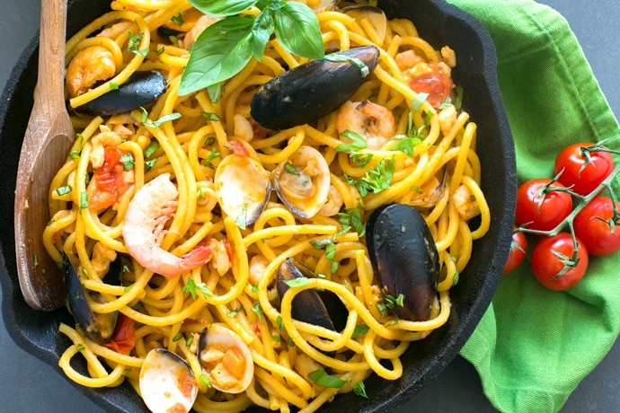 The easiest Seafood Fresh Pasta recipe, made with clams, mussels, squid and shrimp in a creamy and rich tomato sauce. A quick and delicious dinner that you can whip up in less than 20 mins! Recipe by The Petite Cook
