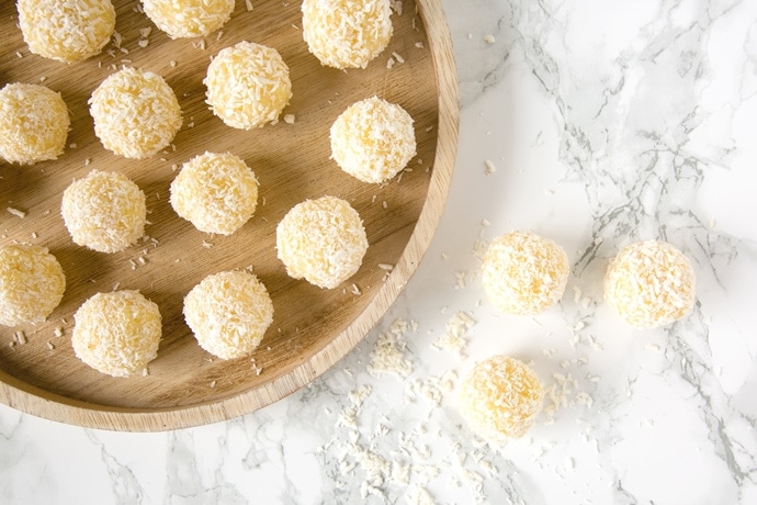 Easy Indian Pineapple Ladoo on a marble worktop and on a wood plate