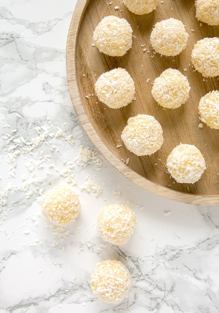 Indian Pineapple Ladoo on a marble worktop and on a wood plate