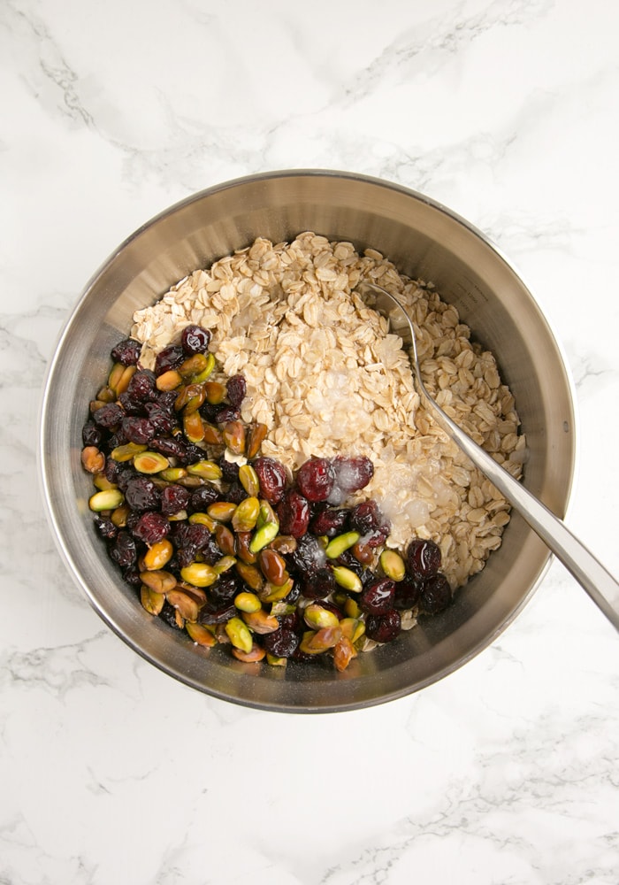 bowl filled with pistachio, cranberries, oats and sugar.