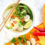 thai turkey meatballs soup in a bowl, with main ingredients on the side
