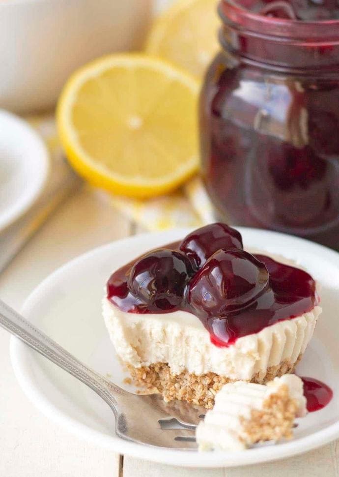 vegan lemon cheesecake topped with cherry sauce.