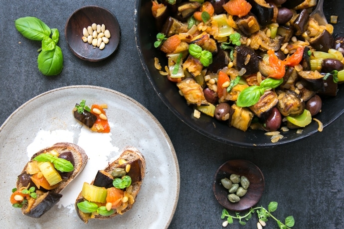 Caponata siciliana served in a pan and as bruschetta.