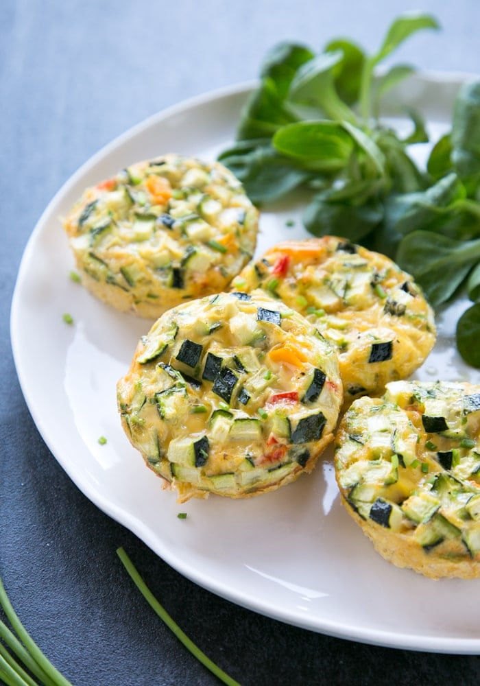 Veggie Omelet Muffins on a white plate with salad