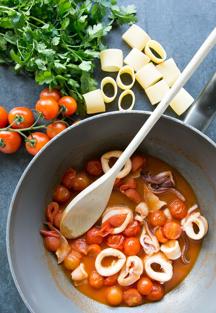 calamari cooked in a pan with tomato sauce