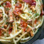 creamy pasta with chanterelle mushrooms and crispy prosciutto, close up.