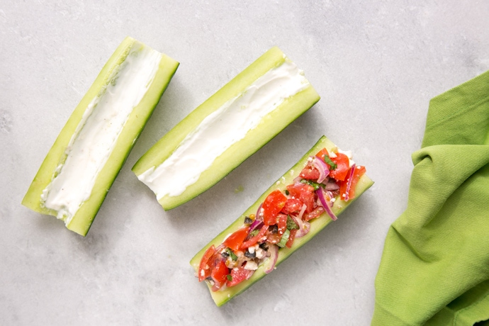 cucumber boats topped with yogurt and greek salad