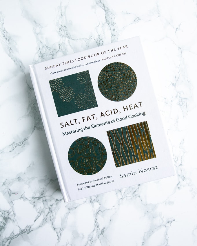 Foodie gift guide: salt, fat, acid, heat cookbook on marble background