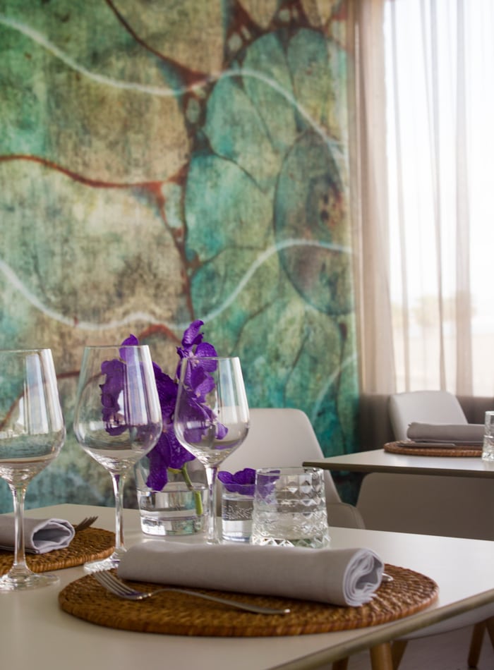 Casa Primavera restaurant interior, table setting and wall decor in the background