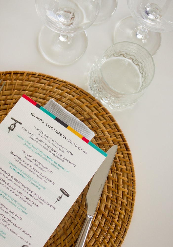 Chef eduardo garcia Primavera Sound menu on white table cloth, with knife and glasses in the background