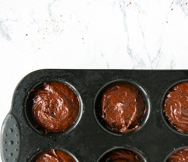 recipe step 2: batter divided among a muffin tin.