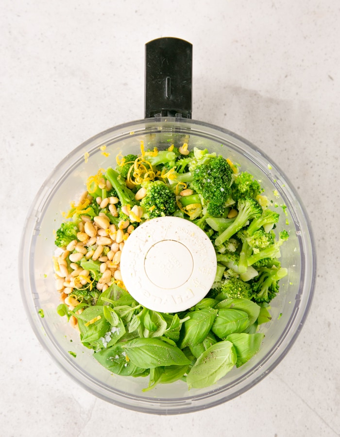 basil leaves, broccoli florets, lemon zest, toasted pine nuts, salt in the bowl of food processor