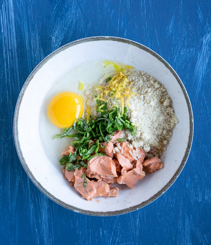 salmon, lemon zest, egg, chopped basil leaves and almond flour in a white bowl