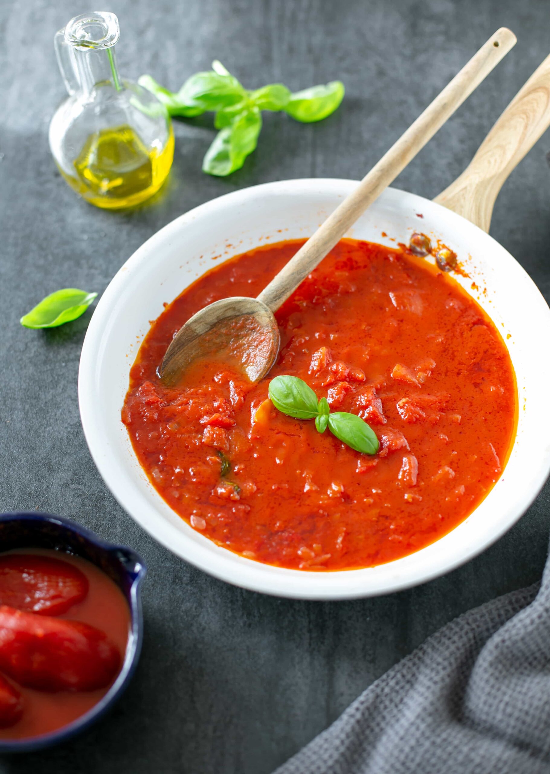 italian tomato sauce in a pan topped with basil leaves.