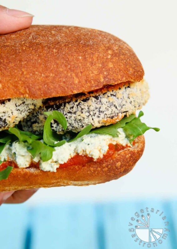 hand holding eggplant parmesan sandwich