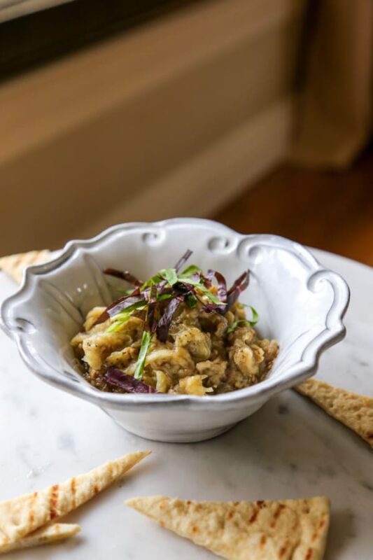 eggplant pate in a small plate served with pita bread