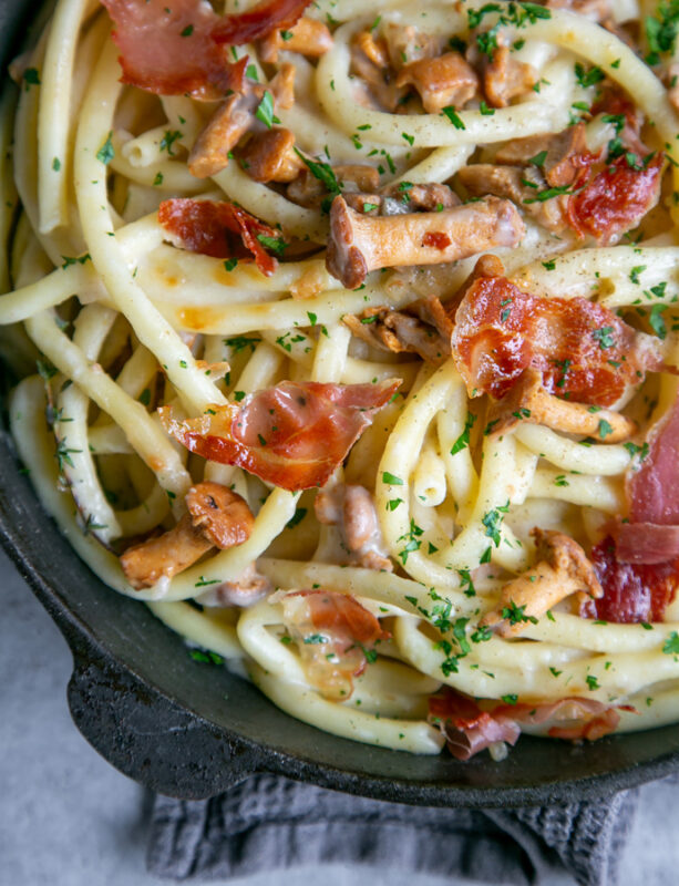 Creamy Chanterelle Mushrooms Pasta with Crispy Prosciutto in cast iron skillet 