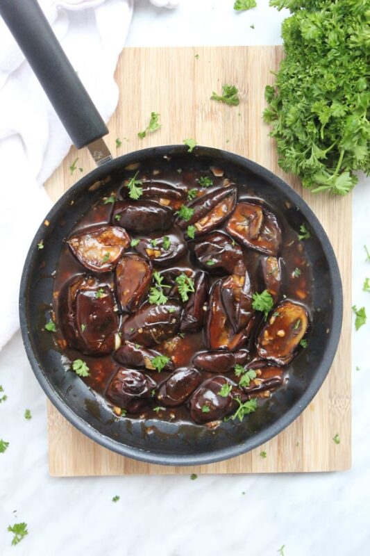 roasted baby eggplant chunks with stir fry sauce in a skillet.