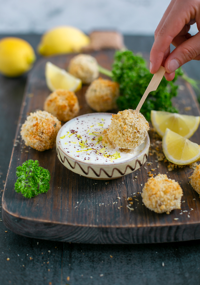 baked fish croquettes served with garlicky yogurt dip and lemon wedges
