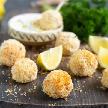 baked fish croquettes served with garlicky yogurt dip and lemon wedges