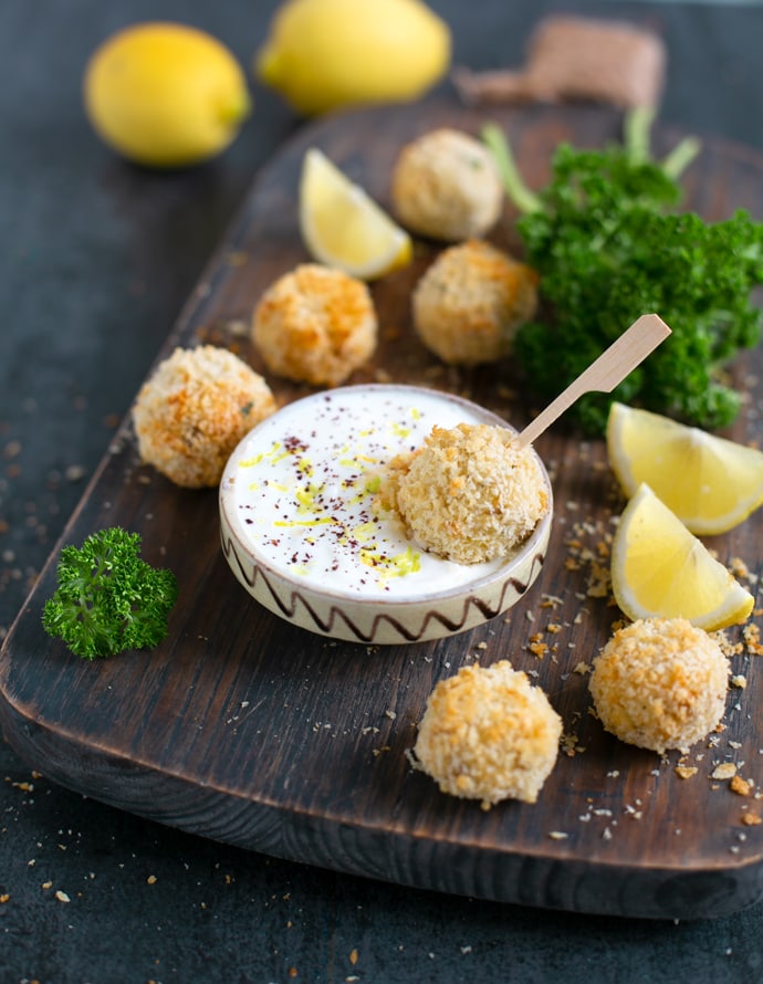 baked fish croquettes served with garlicky yogurt dip and lemon wedges