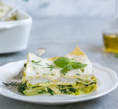vegetarian lasagna with ricotta white sauce served on a plate