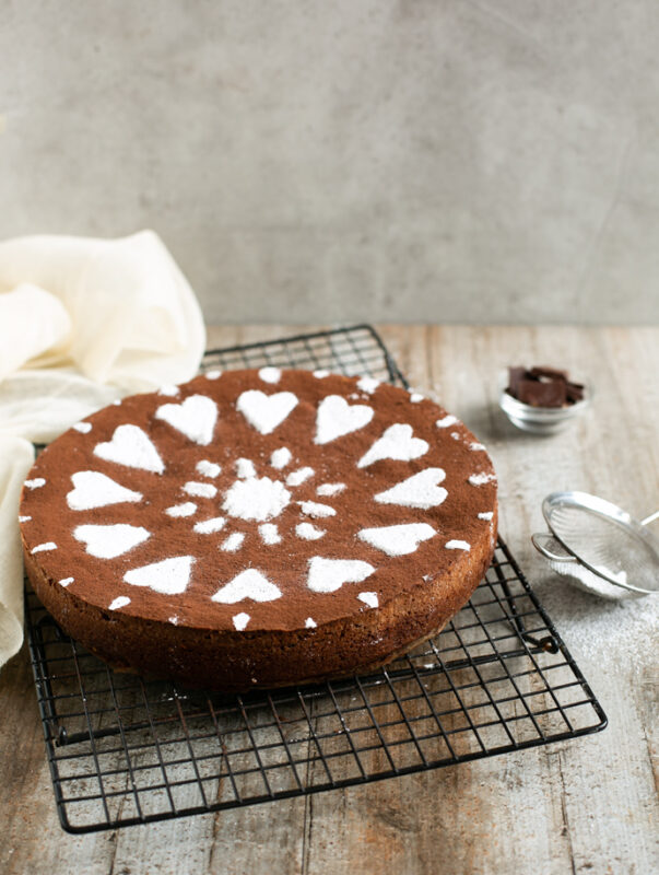 caprese cake on a cooling rack, then dusted with conferctioner sugar right before serving.