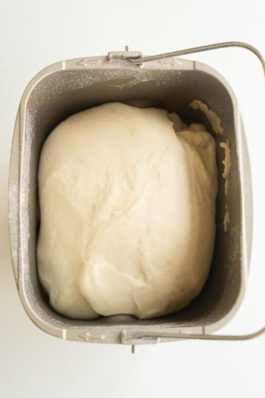 pizza dough in the basket of a bread machine