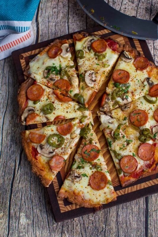 fathead pizza crust topped with tomato, mozzarella, peppers and pepperoni