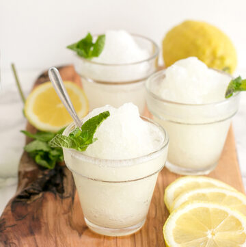 three glasses with lemon granita, topped with mint leaves