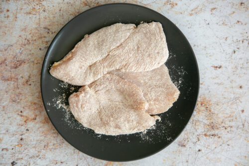 chicken slices coated in flour on both sides.
