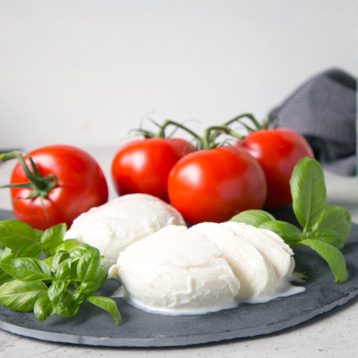 homemade mozzarella balls served with tomatoes and basil leaves.