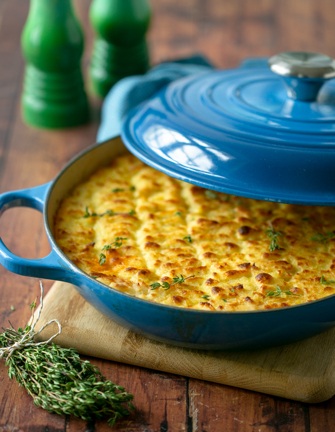 ready to be served cottage pie topped with fresh thyme sprigs.