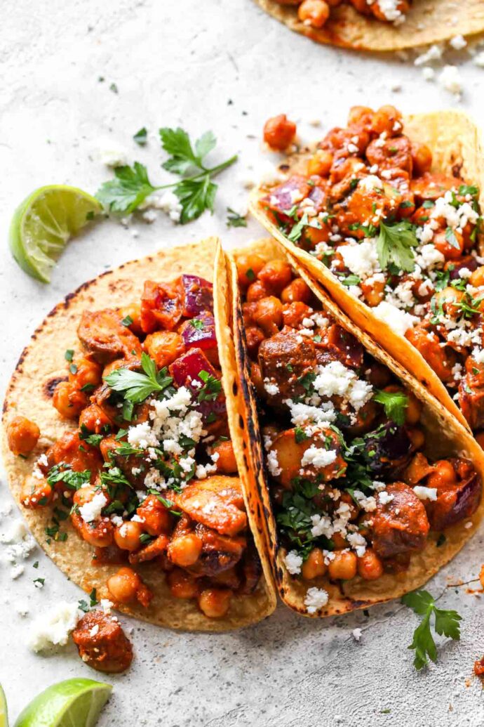 tacos stuffed with chickpeas and topped with cilantro.