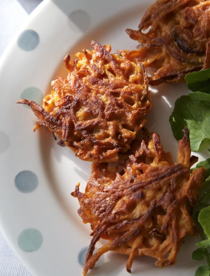 carrot chickpea fritters with salad leaves.