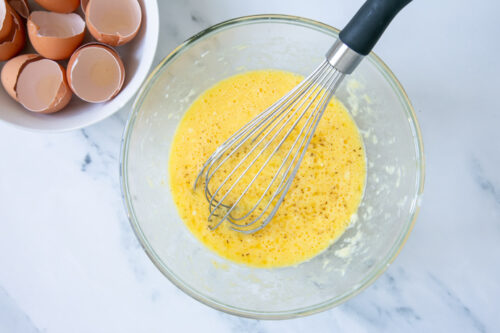 eggs beaten with cheese in a large bowl.