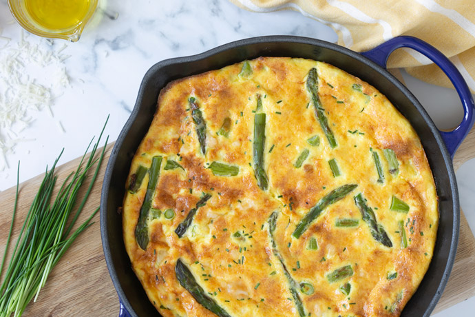 baked asparagus frittata in a cast iron skillet.