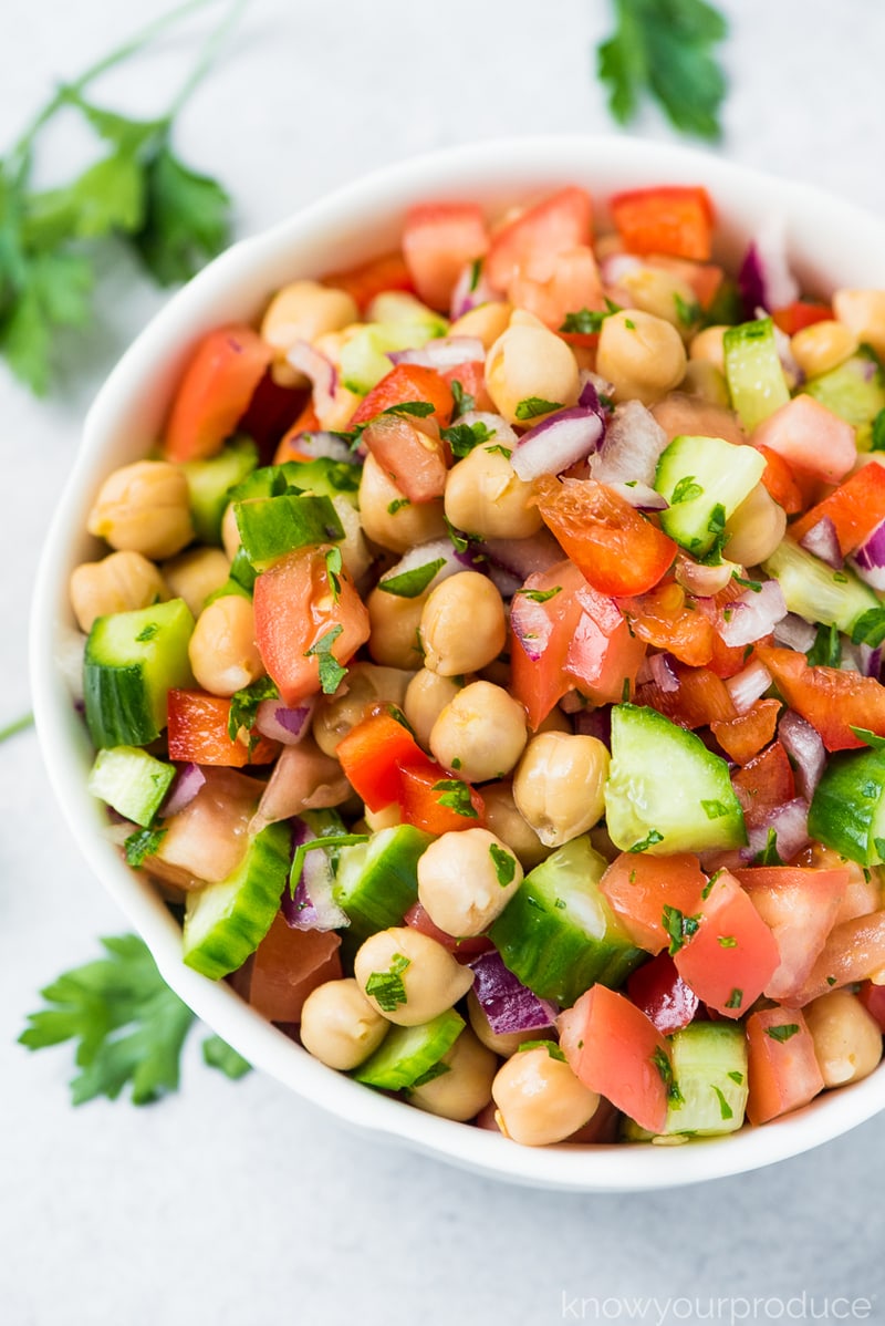 chickpea salad with tomato, cucumber, red onion and parsley.