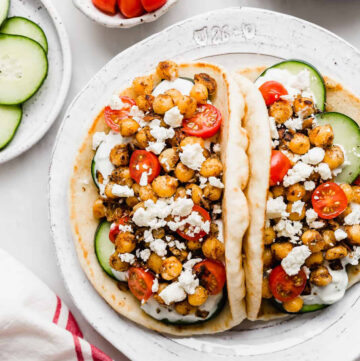 two pita bread stuffed with chickpeas and veggies gyros-style. Image for chickpea recipes round up.