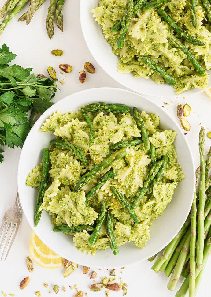 Asparagus pesto pasta topped with asparagus spears.